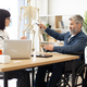 Female doctor talking to male in wheelchair using skeleton - PhotoDune Item for Sale