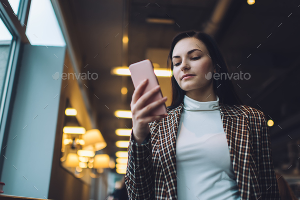 Concentrated young woman text messaging