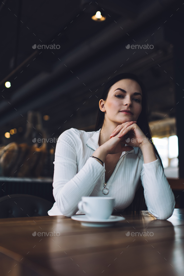 Serious woman in cafe looking at camera