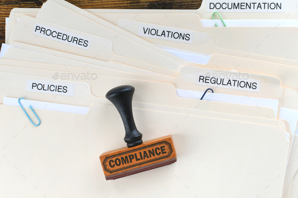 Compliance rubber stamp on folders marked Policies Regulations Violations Procedures Documentation. - Stock Photo - Images