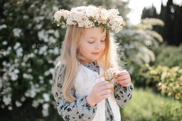 Cute stylish baby girl with flowers outdoor - Stock Photo - Images