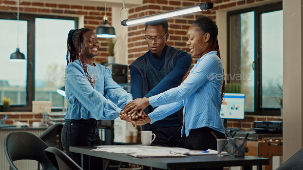 Successful team uniting hands in office - Stock Photo - Images
