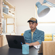Asian man using laptop while working in a home office - PhotoDune Item for Sale
