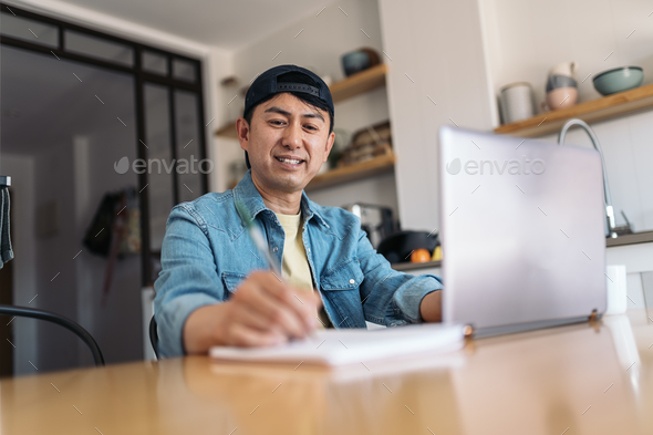 Friendly asian man working from home - Stock Photo - Images