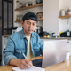 Asian man taking notes while working from the kitchen - PhotoDune Item for Sale