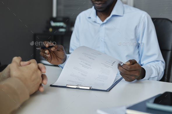 Black man reviewing CV during job interview