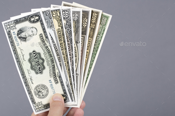 Old Philippine money in the hand on a gray background - Stock Photo - Images