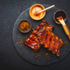 Barbecue pork spare ribs with hot honey chili marinade on black background - PhotoDune Item for Sale