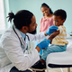 Small black boy about to get vaccinated by pediatrician at doctor&#39;s office. - PhotoDune Item for Sale