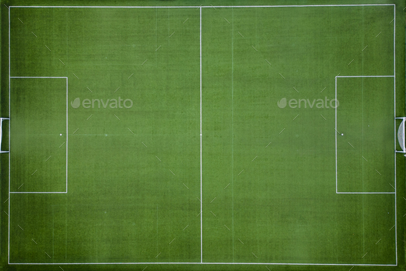 From an aerial perspective, an empty football field comes into view. The neatly mowed grass and the - Stock Photo - Images