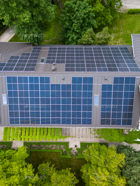 The modern house with a roof designed as a large solar panel, blending style and sustainability. Its - Stock Photo - Images