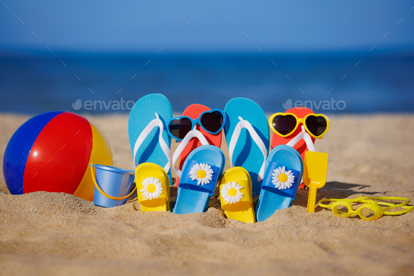 Family flip-flops, beach ball and snorkel on the sand. Summer vacation concept - Stock Photo - Images