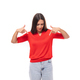 young inspired caucasian brunette woman in a red short sleeve shirt points with her hands to the - PhotoDune Item for Sale