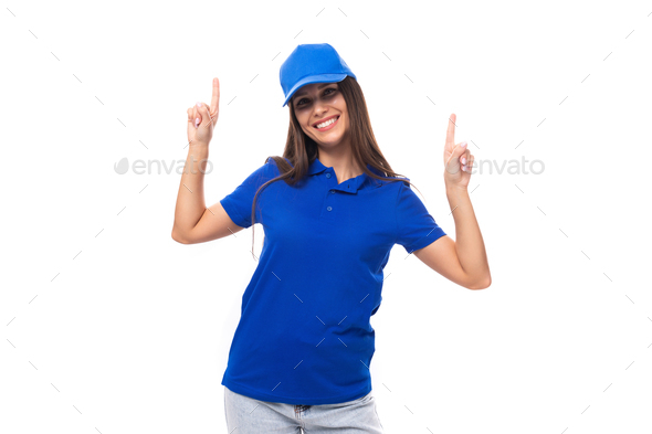 active young brunette woman promoter in blue t-shirt and cap on white background with copy space - Stock Photo - Images