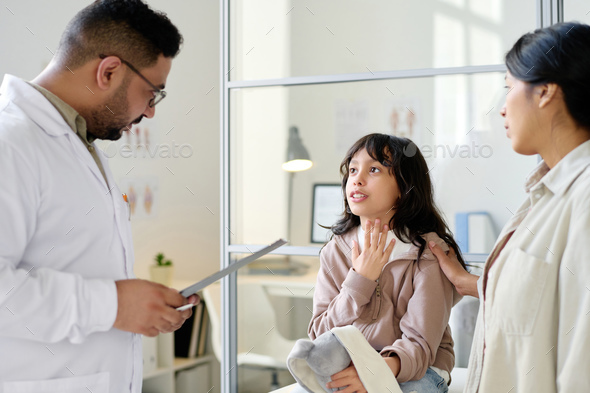 Little girl complaining about her health to doctor - Stock Photo - Images