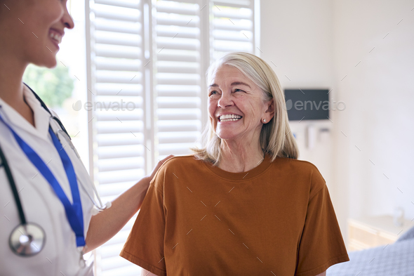 Female Nurse Wearing Uniform Meeting With Senior Woman Patient In Private Hospital Room - Stock Photo - Images