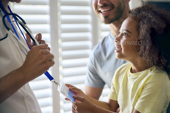 Close Up Of Girl Looking At Nurse's Security Lanyard - Stock Photo - Images