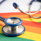 Stethoscope on rainbow flag background, symbol of LGBT pride month. - PhotoDune Item for Sale