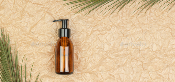 Brown cosmetic bottle with pump on crumpled beige paper background. Body care