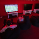 Two boys gamers play football gamepad video game console in red gaming room. - PhotoDune Item for Sale