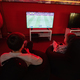 Two boys gamers play football gamepad video game console in red gaming room. - PhotoDune Item for Sale