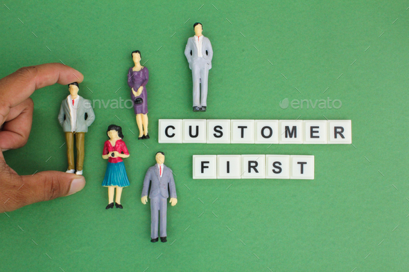 miniature people with the words Customer first.
