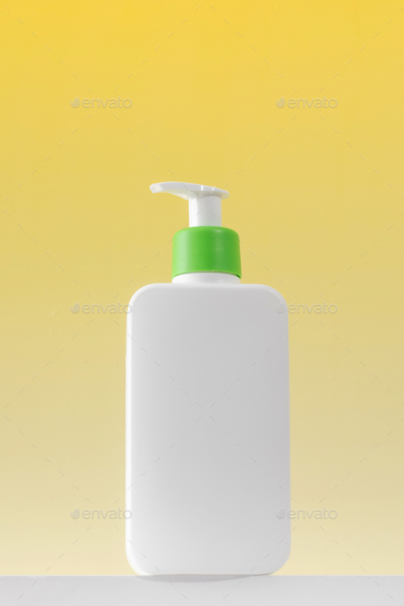 A white dispenser with a cosmetic product for skin care of the body. Shower gel, facial cleanser. - Stock Photo - Images