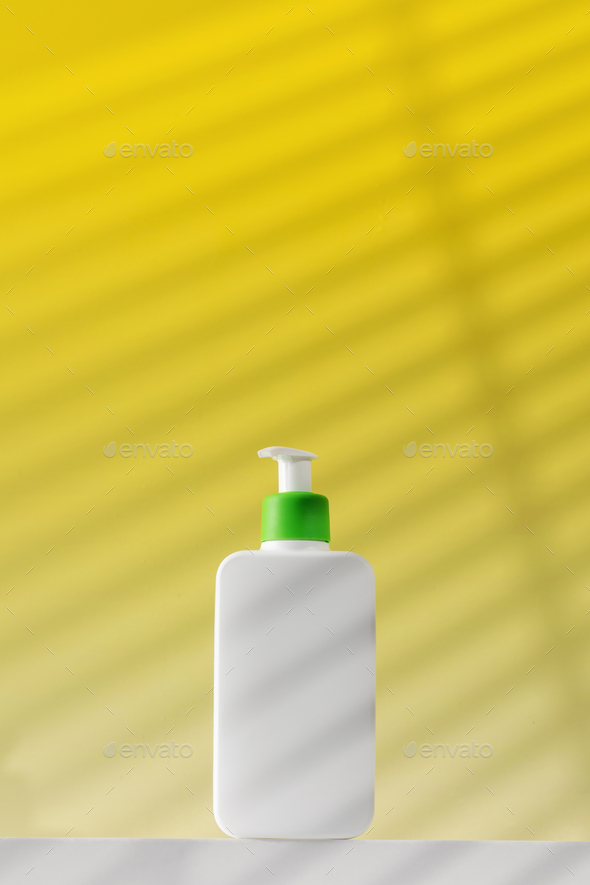 A white dispenser with a cosmetic product for skin care of the body. Shower gel, facial cleanser. - Stock Photo - Images