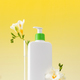 A mockup of a dispenser with a cosmetic skin care product for the face and body with flowers. - PhotoDune Item for Sale
