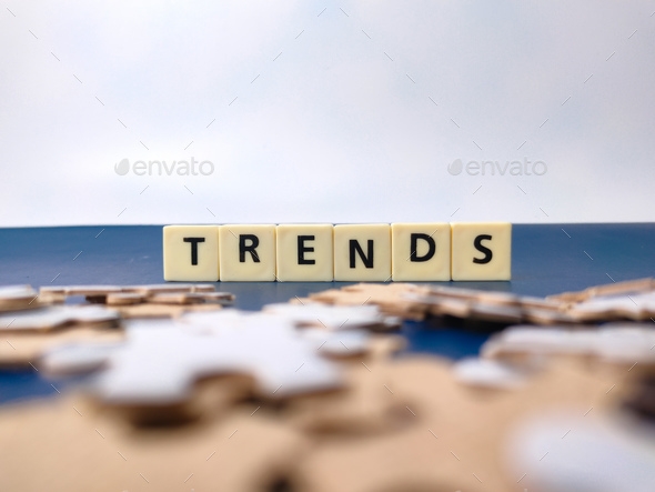 Toys word and jigsaw puzzle with the word TRENDS - Stock Photo - Images