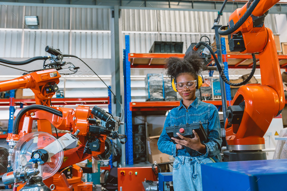 Engineer smart woman worker working programing robotic welding machine