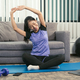 Young Asian woman stretching after her workout at home. - PhotoDune Item for Sale