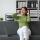 Beautiful woman listening music in headphones sitting on sofa in room. Happy, smiling and relax - PhotoDune Item for Sale