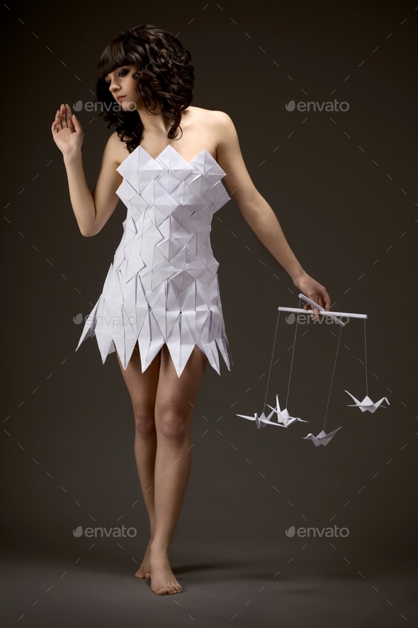 Pensive young girl in an origami dress Stock Photo by YouraPechkin