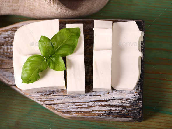 soft feta cheese on a wooden board - Stock Photo - Images