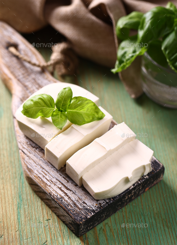 soft feta cheese on a wooden board - Stock Photo - Images