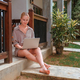 Business.woman working using laptop outdoors home garden.Remote work freelancer travel.cozy green wo - PhotoDune Item for Sale