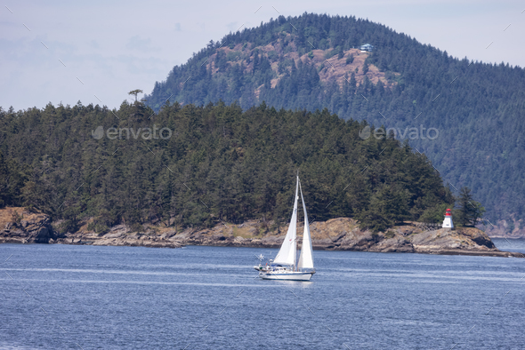 Sailboat in Canadian Landscape by the ocean and mountains. - Stock Photo - Images