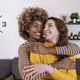 Beautiful and cheerful multiracial lesbian couple hugging and looking each other smiling. Lovely and - PhotoDune Item for Sale