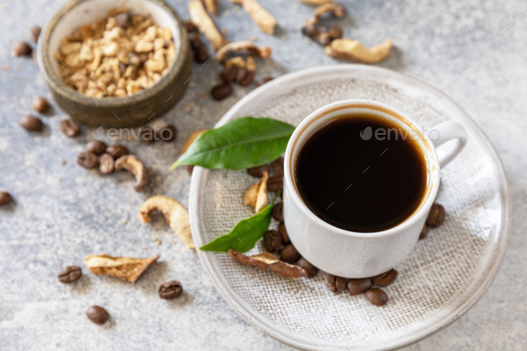 Healthy organic energizing adaptogen, trendy drink. Mushroom coffee in a cup with coffee beans.
