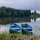 Two wooden boats and a lake surrounded by forest of coniferous trees on a cloudy summer day - PhotoDune Item for Sale