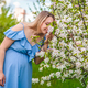 Pregnant woman in the garden of flowering apple trees. Selective focus. - PhotoDune Item for Sale