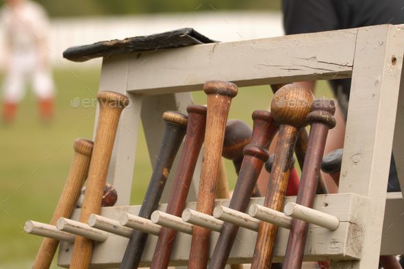 Closeup of old baseball bats arranged in row