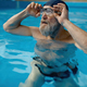 Healthy senior man swimming in indoor pool enjoying sportive lifestyle - PhotoDune Item for Sale