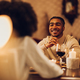 African american couple having romantic date and drinking wine at home - PhotoDune Item for Sale