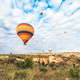 Flying in sky many bright colored beautiful balloons into air in Cappadocia in mountains early at  - PhotoDune Item for Sale