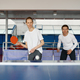 Man and woman in team playing table tennis together indoors - PhotoDune Item for Sale