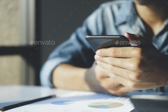 Close up of businessman is analyzing the stock marketing on smartphone.  - Stock Photo - Images