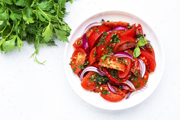 Tomato and onion salad with parsley, garlic, jalapeno and olive oil dressing - Stock Photo - Images