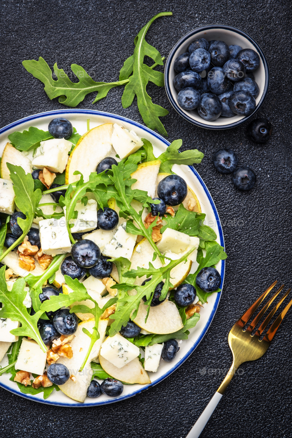 Gourmet salad with sweet pears, blueberries, blue cheese, arugula and walnuts - Stock Photo - Images
